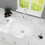White quartz composite kitchen sink with bottom grid and black telescopic basket