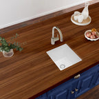 White quartz composite undermount bar sink in a kitchen countertop