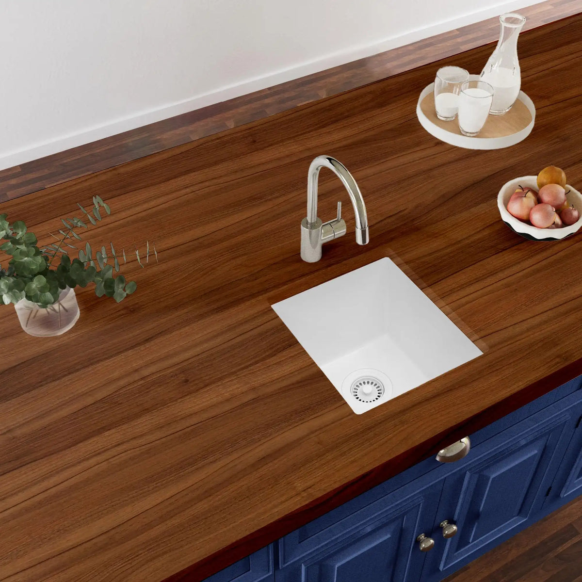 White quartz composite undermount bar sink in a kitchen countertop