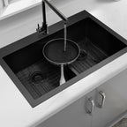 Black double bowl kitchen sink washing a large pan