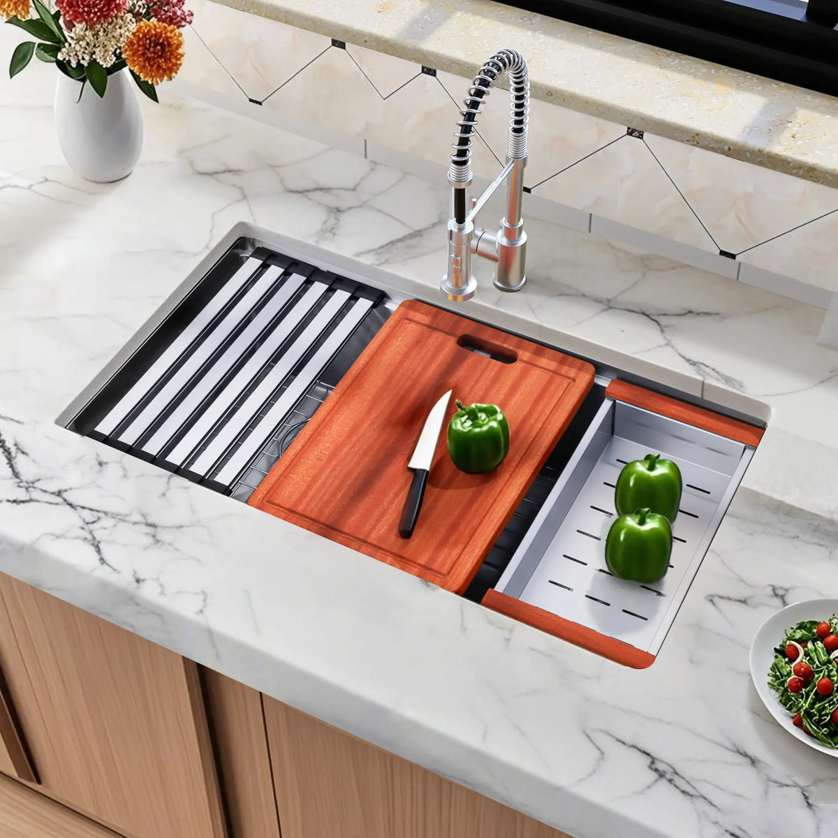 Angled view of double bowl workstation sink with cutting board roll-up rack and colander